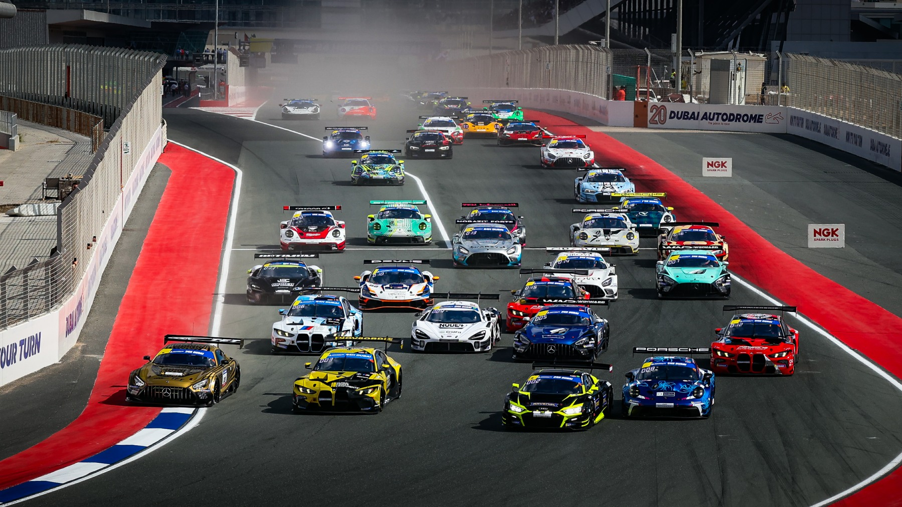 GT3 race cars on the start grid at Dubai Autodrome